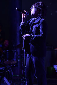 Rear view of man holding umbrella