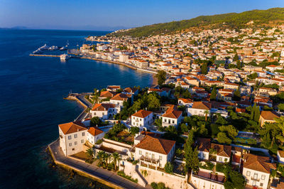 High angle view of townscape by sea against sky