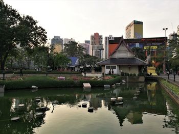 Scenic view of lake by buildings against sky