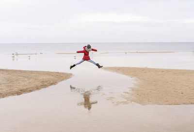 Full length of person on beach against sky