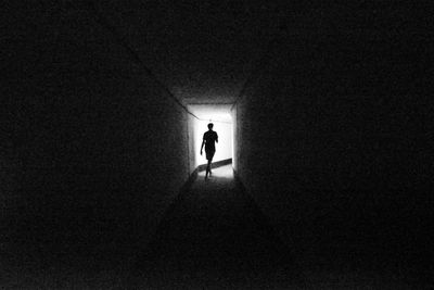 Silhouette person standing in the dark