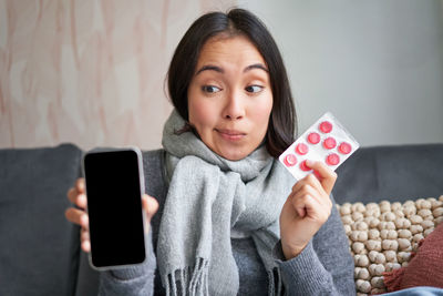 Portrait of young woman using mobile phone