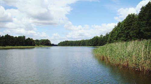 Scenic view of lake against cloudy sky