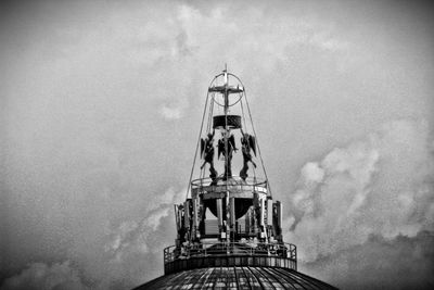 Low angle view of tower against cloudy sky