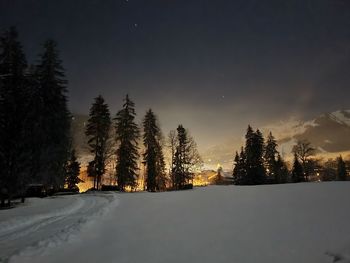 Snow covered landscape against sky during winter