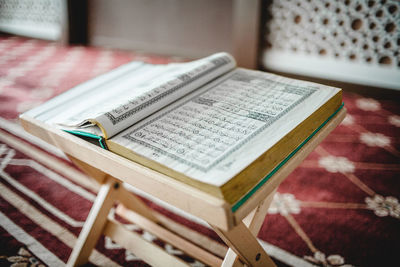 Close-up of open koran on table