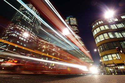 Illuminated city street and buildings at night