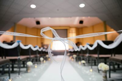 Close-up of ribbon tied in wedding at church