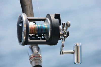 A close-up of the trolling coil against the sea. fishing and fishing supplies.