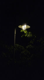 Low angle view of illuminated street light at night