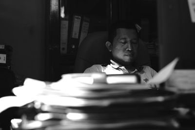 Man sitting on table with books