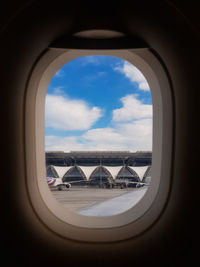 View of cloudy sky seen through airplane window