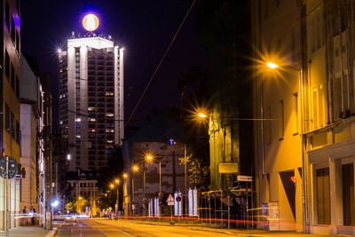 Illuminated city street at night