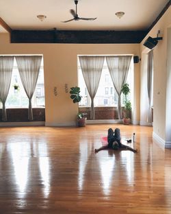 Woman sitting on wooden floor