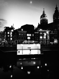 Illuminated buildings against sky at night