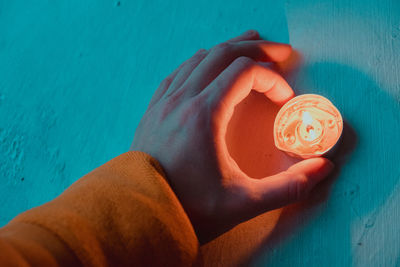 High angle view of hand holding drink in swimming pool