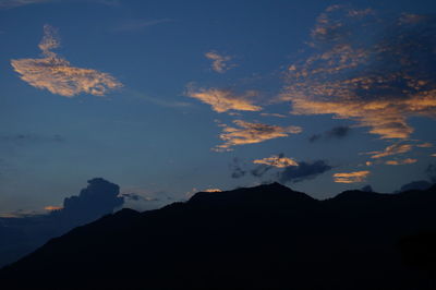 Scenic view of silhouette mountains against sky at night