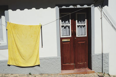 Clothes drying against closed door of building