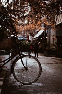 Man riding bicycle on street in rain