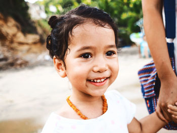 Close-up portrait of cute girl playing