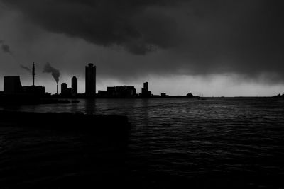 View of cityscape against cloudy sky