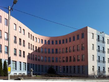 Low angle view of buildings against clear blue sky