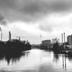 Buildings in city against cloudy sky