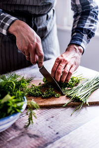 Close-up of man preparing food on cutting board