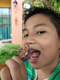 Close-up portrait of boy eating food