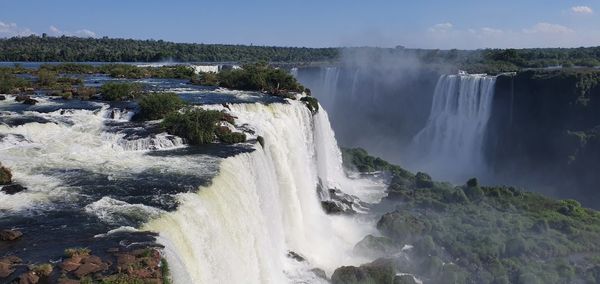 Panoramic view of waterfall against sky