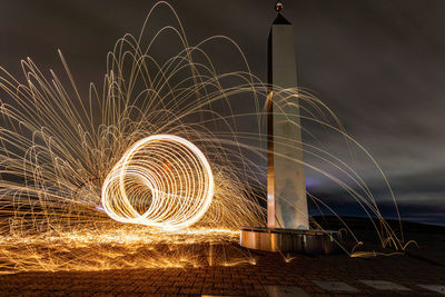 Firework display against sky at night