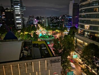 High angle view of illuminated buildings in city at night