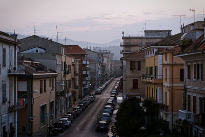 High angle view of street amidst buildings against sky