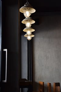 Low angle view of illuminated pendant lights hanging from ceiling