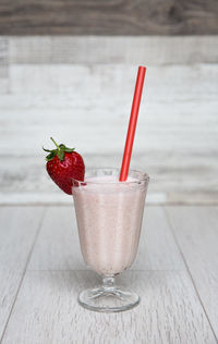 Close-up of strawberry smoothie on table