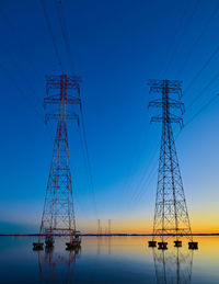 Low angle view of electricity pylon against sky