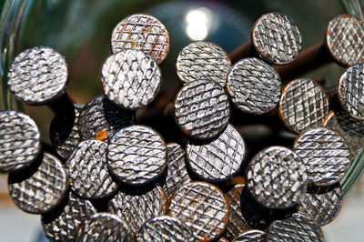 Close-up of nails in glass jar on table