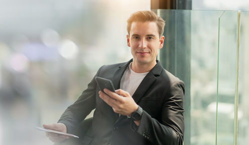 Portrait of young man using mobile phone