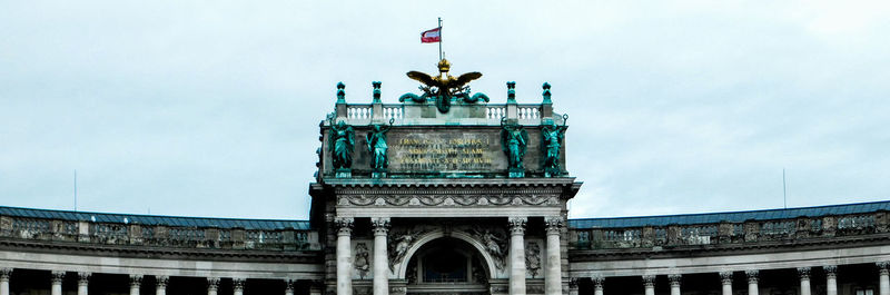 Low angle view of historical building against cloudy sky