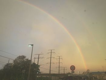 Rainbow over street lights
