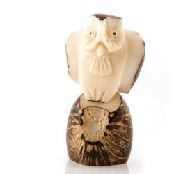 Close-up of figurine on wood against white background