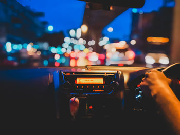 Man photographing through car window at night