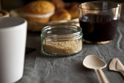 Close-up of jam in glass with sugar on table