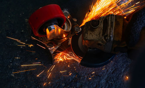 Industrial worker using angle grinder cutting metal. worker working with angle grinder and has spark