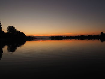 Scenic view of lake at sunset