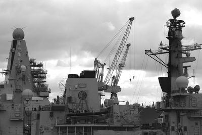 Cranes against sky in city