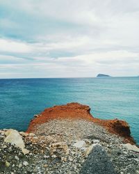 Scenic view of sea against cloudy sky