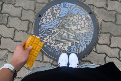 Low section of person standing on tiled floor