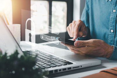 Midsection of man using laptop