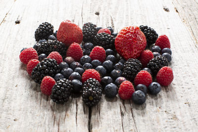 Close-up of strawberries , raspberries and black berries on table
